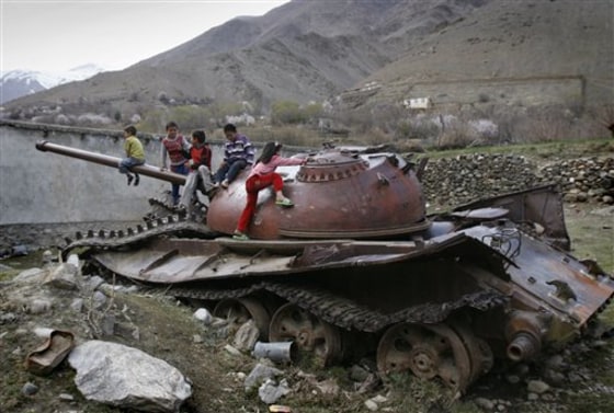 Afghan children play on a destroyed Soviet-made armored tank in Panjshir north of Kabul, Afghanistan, on March 26.
